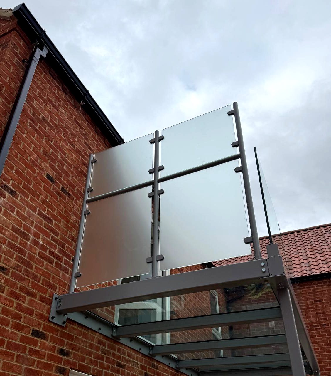 1800mm high frosted toughened glass privacy screen on tubular posts to a balcony, Rutland